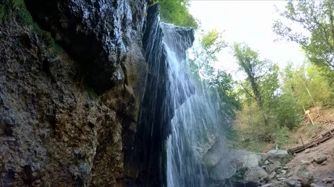 A small waterfall breaks from the stones Stock-Footage 84788535