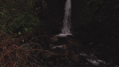 Small Waterfall cascade coming down gentle from a rocky cliff. HD. Stock Footage 138716371