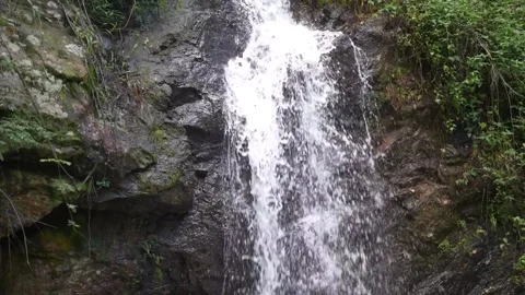 Small waterfall cascading down rocks Stock Footage 276323250