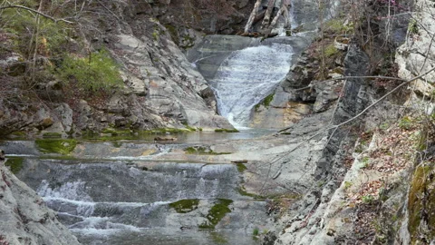 Small Waterfall Cascading Over Rock at Natural Bridge State Park Virginia  Stock Footage 332039939