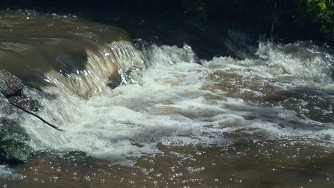 Small Waterfall Cascading over Rocks in Tropical Forest. Slow motion Stock Footage 92380809