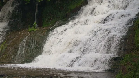 Small Waterfall Cascading over Rocks in Tropical Forest. Slow motion Stock Footage 92447126