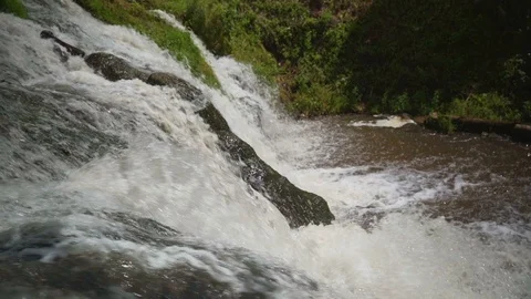 Small Waterfall Cascading over Rocks in Tropical Forest. Slow motion Stock Footage 92448068