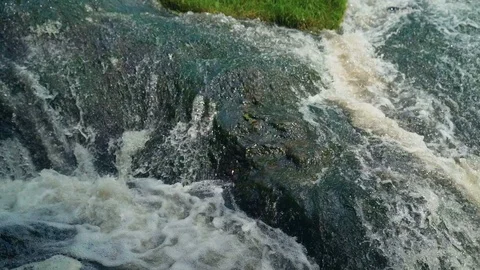 Small Waterfall Cascading over Rocks in Tropical Forest. Slow motion Stock Footage 92473464