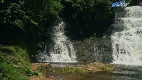 Small Waterfall Cascading over Rocks in Tropical Forest. Slow motion Stock Footage 92493926