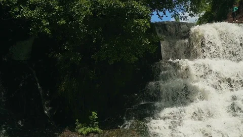 Small Waterfall Cascading over Rocks in Tropical Forest. Slow motion Stock Footage 92498257