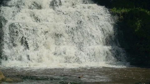 Small Waterfall Cascading over Rocks in Tropical Forest. Slow motion Stock Footage 92502105