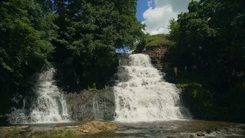 Small Waterfall Cascading over Rocks in Tropical Forest. Slow motion Stock Footage 92505140