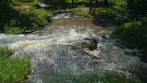 Small Waterfall Cascading over Rocks in Tropical Forest. Slow motion Stock Footage 92508407