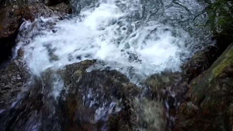 Small Waterfall Cascading Over Rocks Stock Footage 299199988
