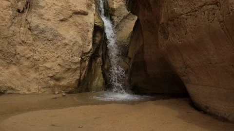 Small waterfall cascading into a serene pool within the oasis of Tozeur, Video stock 266883209