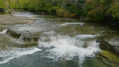 Small Waterfall cascading through the forest still Stock Footage 256942171