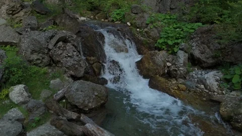 Small waterfall on a clear mountain stream in early summer (June), crystalline w Stock-Footage 324949803
