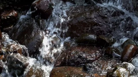 Small waterfall with clear water flowing through natural rocks Stock-Footage 291918061