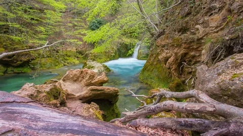 Small waterfall in a colorful river Stock Footage 81167013