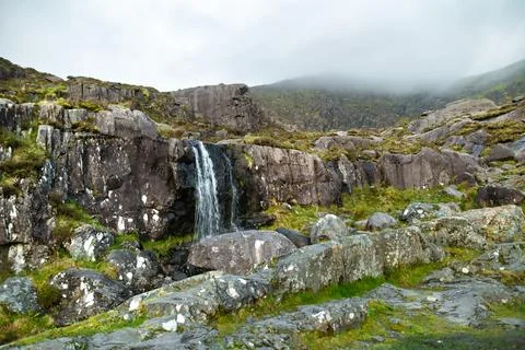 Small waterfall at the Conor Pass, one of the highest Irish mountain passes s 스톡 사진