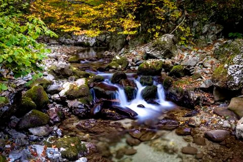 Small waterfall on a crystal clear river Foto stock