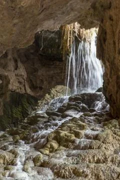 Small waterfall falling over rocks in the Kaklik cave, Denizli, Turkey Stock Photos