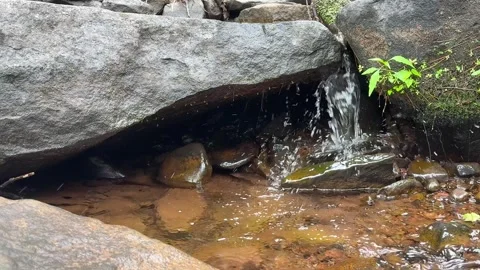 Small Waterfall Flowing Beneath Granite Boulder in Burnt Meadow Brook, New Y Stock Footage 340986818