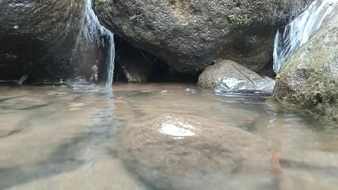 Small Waterfall Flowing Into Clear Rocky Creek Pool Stock Footage 329800522