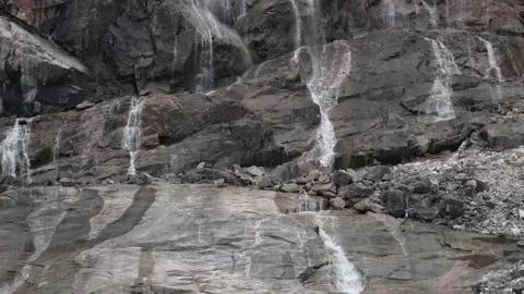 Small Waterfall Flowing Down Rocky Cliff Near Ilulissat Greenland Stock Footage 345559167