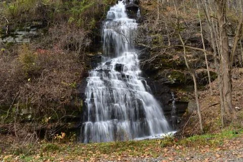 A Small Waterfall Flowing Down a Steep Cliff Stock Photos