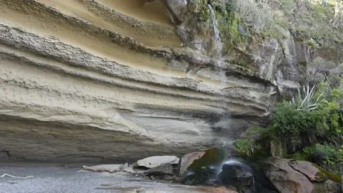 Small waterfall flowing over cliffs, New Zealand. Stock Footage 146989925