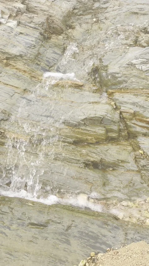 Small Waterfall Flowing Over Natural Rock Formation Video stock 330267300