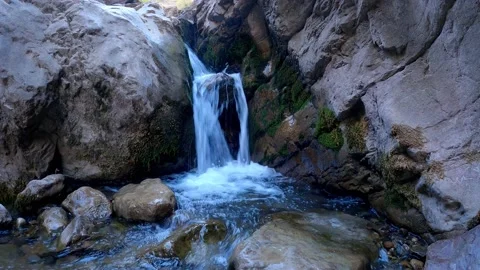 A small waterfall flowing over the rocks Stock Footage 171444960