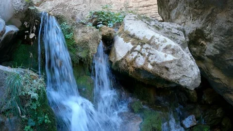A small waterfall flowing over the rocks Stock Footage 171559313