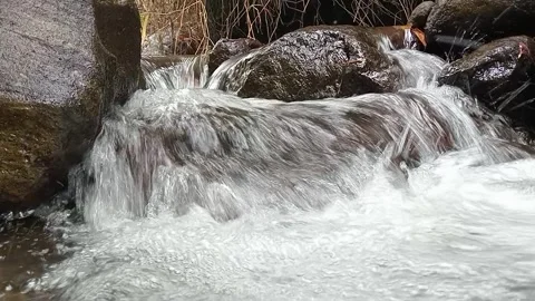 Small Waterfall Flowing Over Rocks – Natural Forest Cascade Stock Footage 330548153