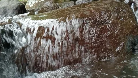 Small Waterfall Flowing Over Rocks in Forest Natural Scene Stock Footage 330570378