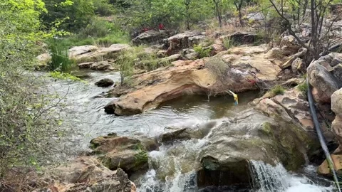 Small Waterfall Flowing Over Rocks in Forest Stream, Natural India Stock Footage 331800635