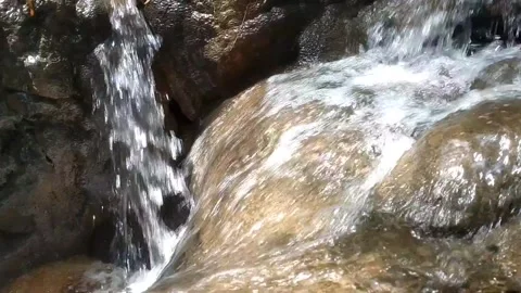 Small Waterfall Flowing Over Rocks Stock Footage 332156540