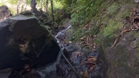 Small Waterfall Flowing Over Rocks Stock Footage 332540532