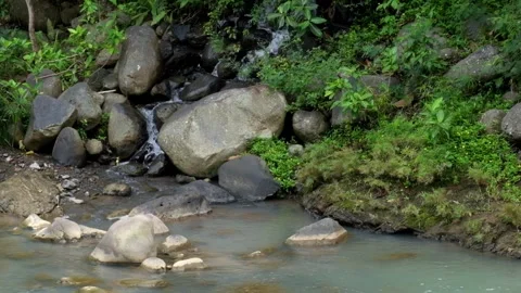 A small waterfall flowing into a river 스톡 동영상 336878786