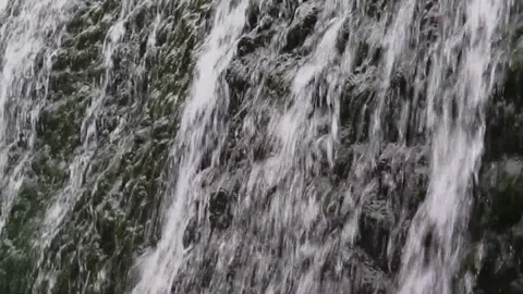 A small waterfall flowing through stones 스톡 동영상 148254059