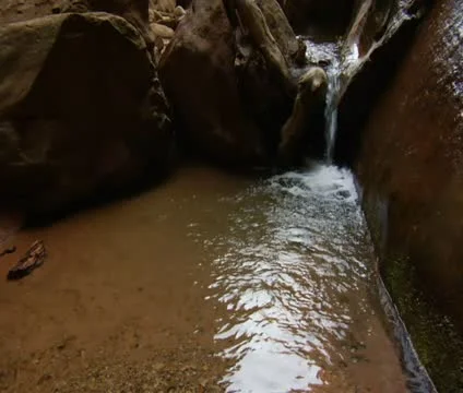 A small waterfall flows into redrock creek Video stock 21683993