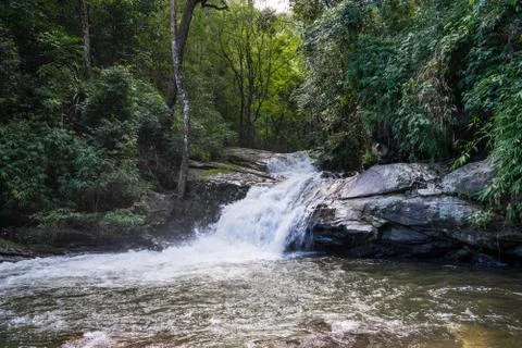Small waterfall that flows into a river Stock Photos