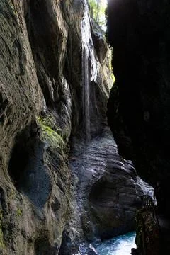 A small waterfall flows from the top over the rocks Stock Photos