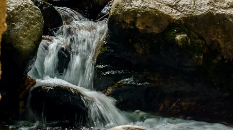 Small waterfall focus pull and dolly push in Stock Footage 38483833
