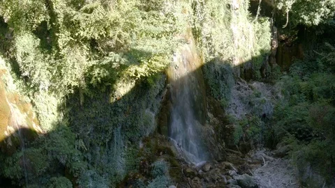 Small waterfall in a forest - 4K Stock Footage 79639090
