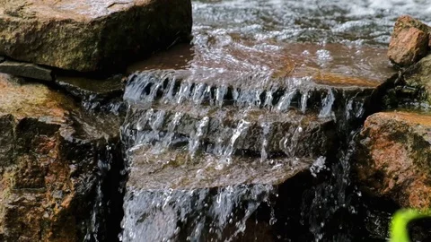 Small waterfall in garden decorative. Cold transparent water Stock-Footage 113362899
