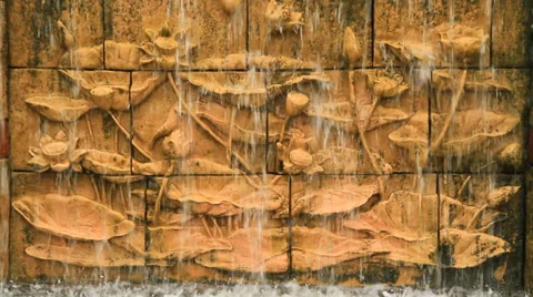 Small waterfall on Lotus statue wall at garden Stock Footage 32241564