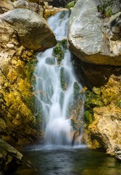 Small waterfall on mountain brook Stock Photos