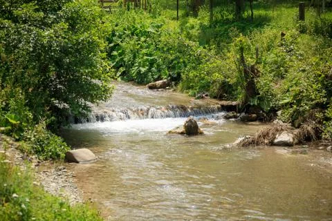 Small waterfall on a mountain river Stock Photos