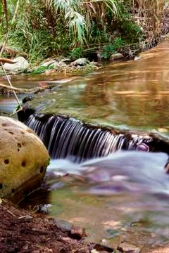 Small waterfall in a mountain river Stock Photos