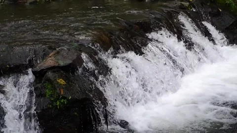 Small waterfall from mountain spring Video stock 303390597