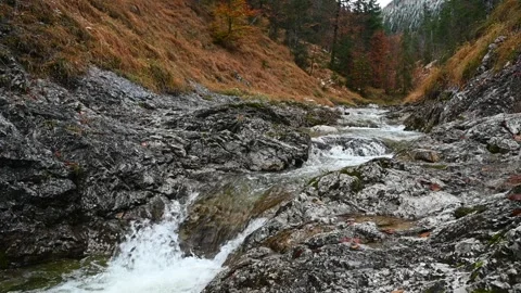 Small waterfall from a mountain stream in autumn (slow motion) Video stock 260848086