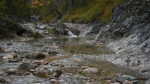 A small waterfall of a mountain stream in autumn Stock-Footage 260862318